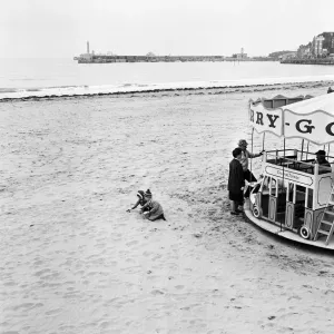 Scenes in Margate, Kent, during Good Friday. Two toddlers playing on the beach besides a Scenes in Margate, Kent, during Good Friday. Two toddlers playing on the beach besides a
