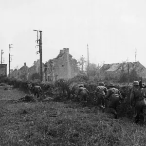 Black and white print of a patrol searching for snipers in Hottot village