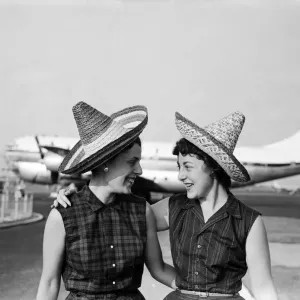 School teacher, 23 year old Phyllis Kaulfman (left), is not short of hats for her flight