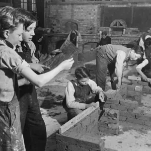 Black and White Print of Schoolboys Building Small Houses Black and White Print of Schoolboys Building Small Houses