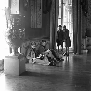 Two schoolboys look on as artists sketch in the public library in the Pavilion in