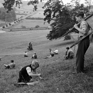 Schoolboys from West Wycombe go tobogganing on a hill in the village. circa 1945