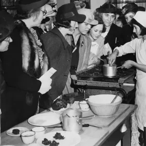 Schoolgirls demonstrating cooking to their mothers at Orange Hill School in Burnt Oak Schoolgirls demonstrating cooking to their mothers at Orange Hill School in Burnt Oak
