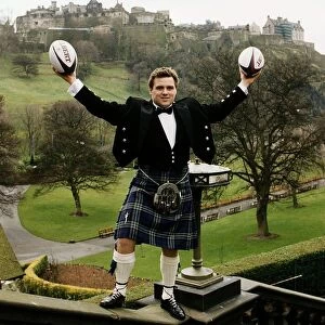 Scotland and Bath Rugby Union player David Hilton wearing kilt standing on wall holding
