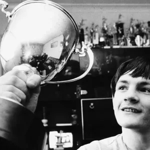 Scotlands new ABA Featherweight Champion holds up hi trophy