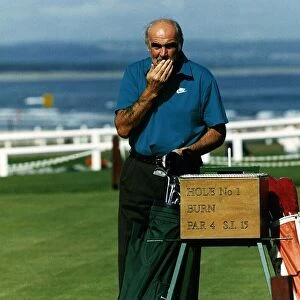 Sean Connery at first hole St Andrews golf course hand on moustache golf bag clubs