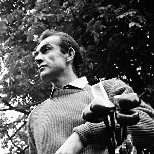 Sean Connery playing golf near new house in Acton. The house was once a Convent