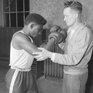 Senior trainer Bill Davies show a 19 year old West Indian, Randolph Bottley