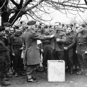Sergeant Major issuing comforts to soldiers of the Suffolk Regiment