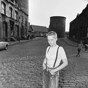 Seventeen year old skinhead teenager Janet Askham poses in the street at her home in