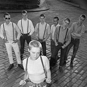 Seventeen year old skinhead teenager Janet Askham poses with her friends at her home in