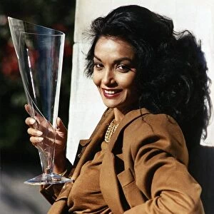 Shakira Caine wife of actor Michael Caine holding a long glass