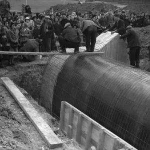 Shelters for Schools. Parents watch the construction of one of the air raid shelters Shelters for Schools. Parents watch the construction of one of the air raid shelters