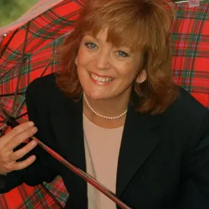 Sherrie Hewson cornation St actress holding a tartan umbrella Sherrie Hewson cornation St actress holding a tartan umbrella