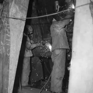 Shipbuilders at the King George V dry dock in Southampton replace damaged hull plates of Shipbuilders at the King George V dry dock in Southampton replace damaged hull plates of