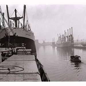 Ships unloading in the docks at Manchester seen through the mist May 1967