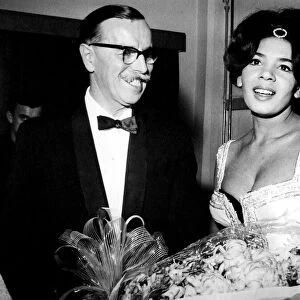 Shirley Bassey is presented with flowers by the General Manager of the Capitol Theatre