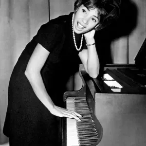 Shirley Bassey tries her hand at the piano during a press conference in the Cocktail Shirley Bassey tries her hand at the piano during a press conference in the Cocktail