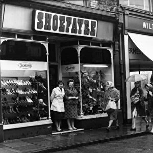 Shoppers brave the rain in Hannah Street, Porth November 1964