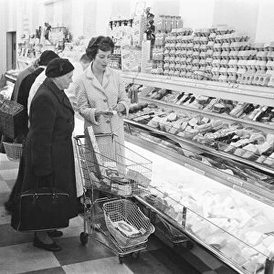 Shoppers browsing the dairy counter at a newly opened self service food store in North