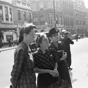 Shoppers looking for a bargain read the small ads outside a Earls Court News Agents