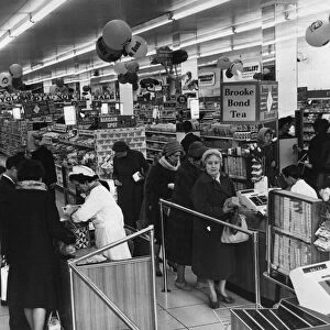 Shoppers pay for their goods at a supermarket in Cardiff, Wales, 16th May 1963