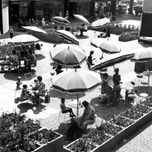 Shoppers relaxing below the circular Godiva Cafe in the Lower Precinct