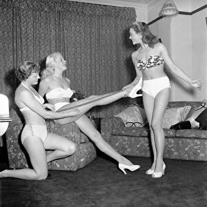 Three showgirls limber up in their digs before a performance. 1959 E09-004