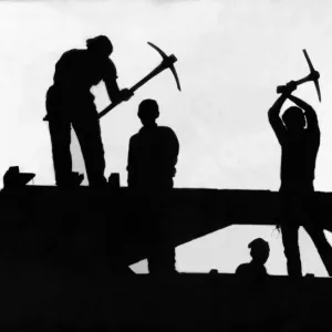 A silhouette of four demolition workers perched high above Newgate Street