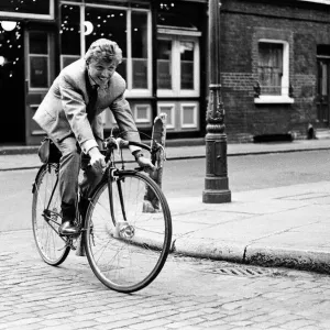 Singer and actor Tommy Steele riding his bicycle. 5th April 1963