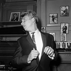Singer and Actor Tommy Steele tries on his wedding suit. 1960