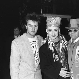 Singer Boy George poses with Paul Young (left) and Elton John (right