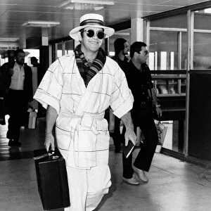 Singer Elton John pictured at Heathrow airport. 11th April 1982