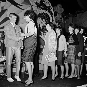 Singer Johnny Leyton greeted by a long line of teenage girls hopeful for autographs after