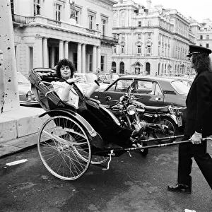 Singer Marc Bolan in a rickshaw in London. Drawing the rickshaw is Alphie O Leary