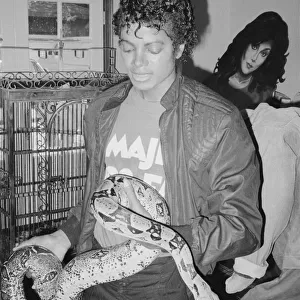 Singer Michael Jackson with his pet Muscles the boa constrictor at his home in California