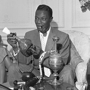 Singer and pipe collector Nat King Cole seen here with his collection of pipes in his