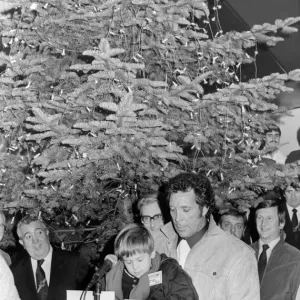Singer Tom Jones, assisted by his grandson Alexander Woodward