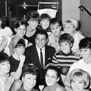 Singer Tony Bennett surrounded by chorus girls. 7th November 1965 Singer Tony Bennett surrounded by chorus girls. 7th November 1965