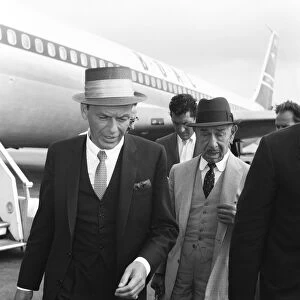 Singers Frank Sinatra and Dean Martin seen here at Heathrow Airport shortly after their