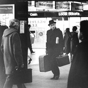Sir Alec Douglas Home looking vague at railway station carrying luggage - February 1979