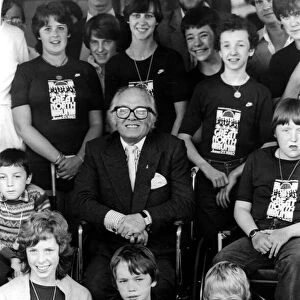 Sir Richard Attenborough with children involved in a sponsored wheelchair push in