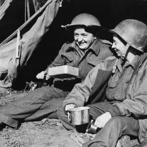 Sister E. C. Cowell and Miss R. E. Donahoe of the American Field Surgical Team drinking Sister E. C. Cowell and Miss R. E. Donahoe of the American Field Surgical Team drinking