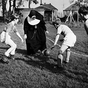 Sister John Gabriel deputy head mistress coaching the schools football team. 1965
