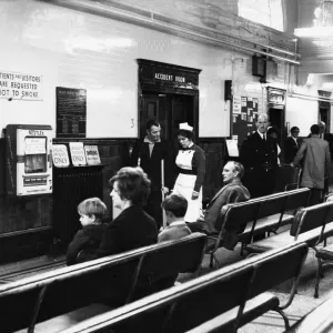 Sister Marjorie Cook talks to an out patient in the hall at at Ancoats Hospital in Mill