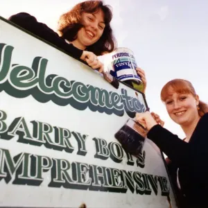 Sixth form pupils Anne-Marie Toms aged 17 and Hannah Wilton aged 18 paint the word Boys