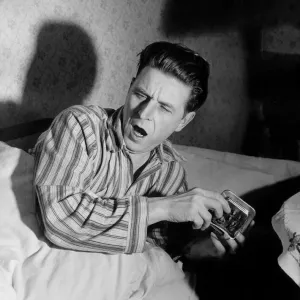 Sleepy Man. A man wakes up, yawning, turns off his alarm clock Sleepy Man. A man wakes up, yawning, turns off his alarm clock