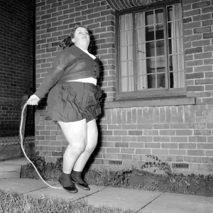 Slimming: Large woman skipping to get fit. A145-001 Slimming: Large woman skipping to get fit. A145-001
