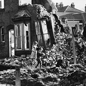 Slum housing in Birmingham. Children play and collect firewood amongst the wreckage