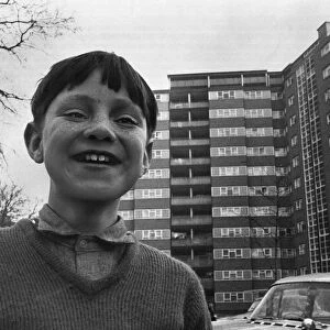 A small boy plays outside a block of flats in Stockwell South London Image used